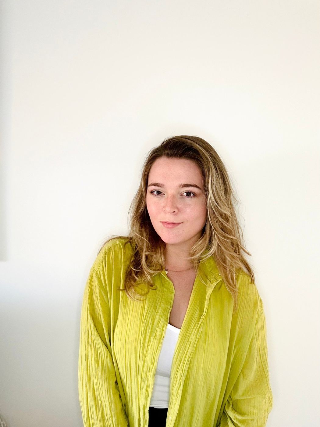 Indi in a lime green top, smiling